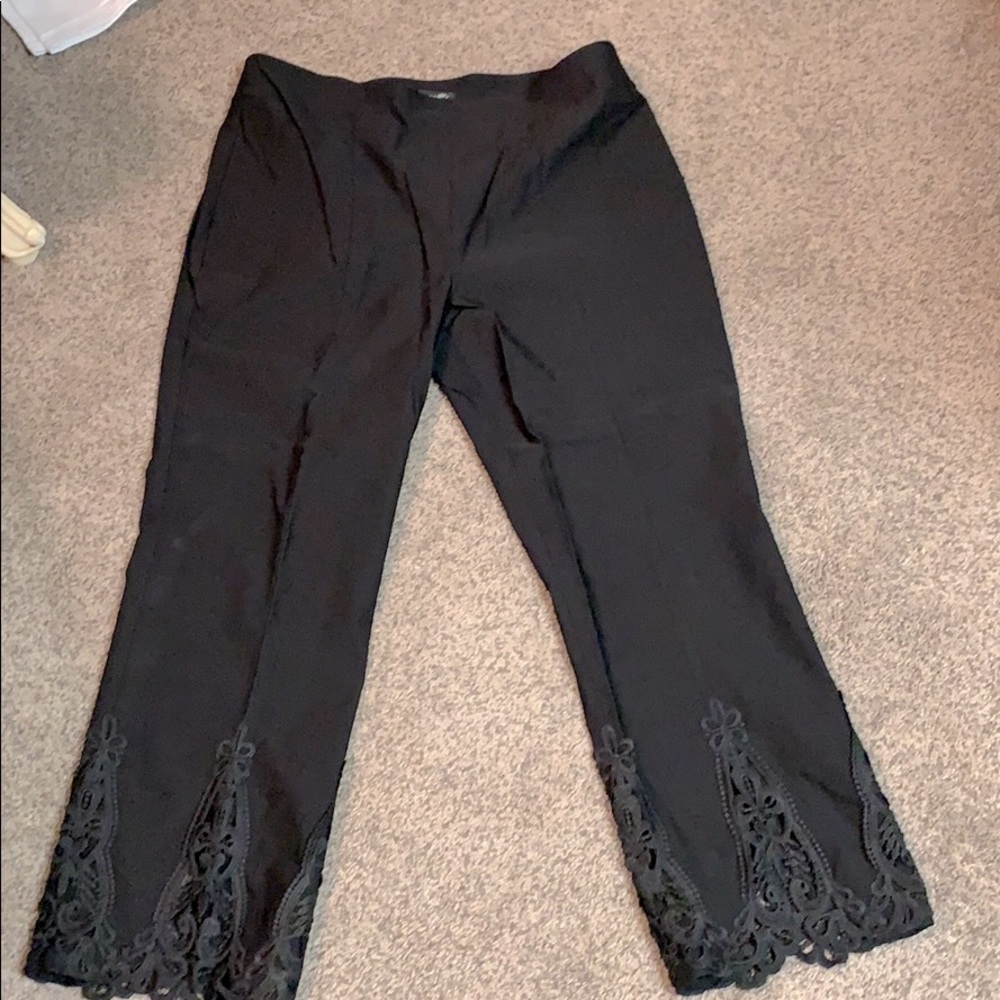 Black dress pants with detailed lace bottoms.